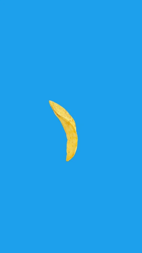 Flying Potato Chip Rotating 180 Degrees on Blue Background – Vertical Video Stock Footage 312147601
