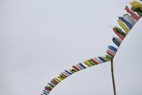 Flying prayer flag of many - colored Stock Photos