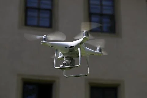 Flying quadcopter with digital camera on blurred background Stock Photos