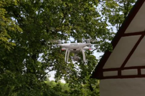 Flying quadcopter with digital camera on blurred background Stock Photos