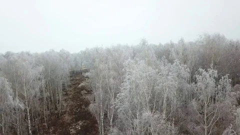 Flying quadcopter over the road in the winter Stock Footage 82752677