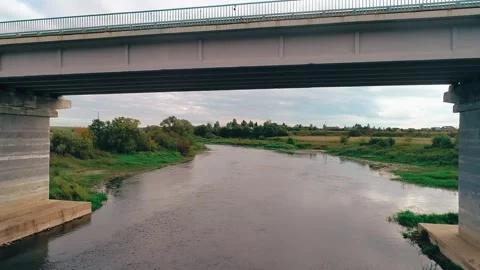 Flying a quadcopter under the bridge at sunset time. Stock Footage 150904445