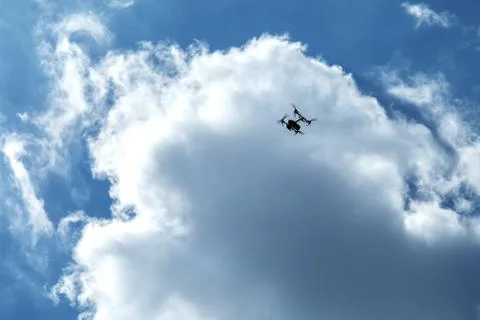 Flying quadrocopter on a background of clouds and blue sky 스톡 사진