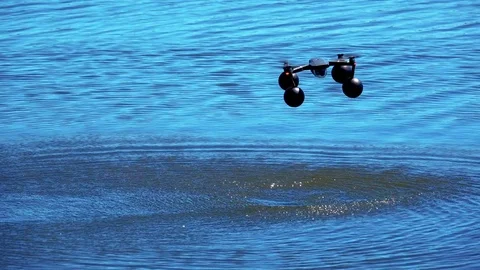 Flying a quadrocopter drone over the water Stock Footage 76167213
