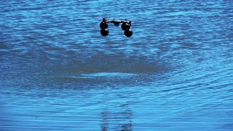 Flying a quadrocopter drone over the water Video stock 76168047