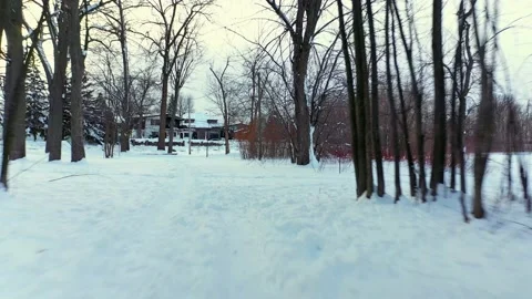 Flying quickly backward over the foot tracks left in the white snow in a walk Stock Footage 164343833
