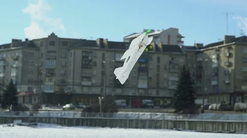Flying radio controlled airplane model on winter Lake Stock Footage