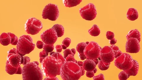 Flying of Raspberry in Orange Background Stock Footage 129402900