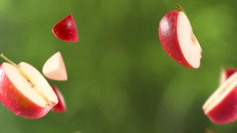 Flying of Red Apple and Slices in Garden Background Stock Footage 123502402