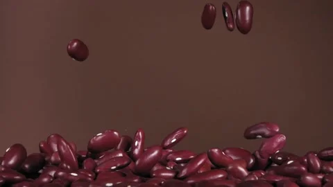 Flying red beans on a brown background. Super slow motion. Stock Footage 150183019