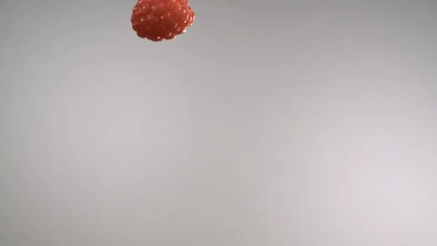 A flying red raspberry passing through in front of the camera Stock Footage 161526303