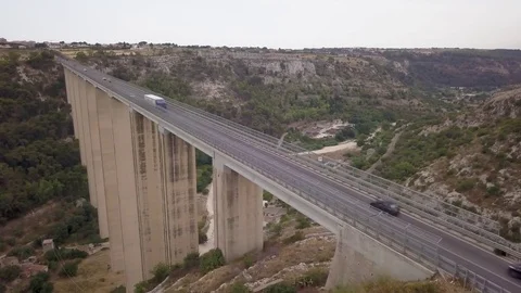 Flying right over roadway of Modica viaduct Stock Footage