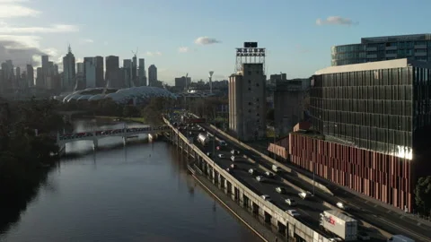 Flying up River Alongside Monash Freeway with Afternoon Traffic &amp; Melbourne Stock Footage 208362560