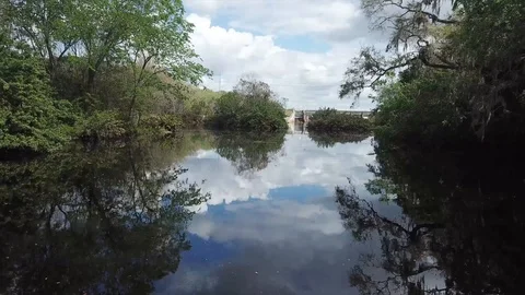 Flying Up The River to Damn and Waterfall Drone Stock Footage 88962797