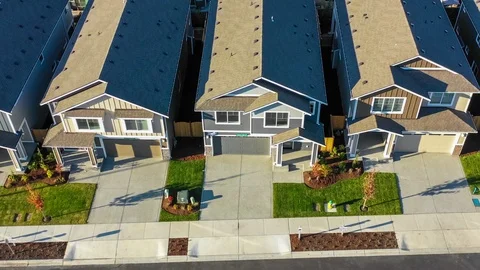 Flying by a row of new construction homes for sale Stock Footage 95765492