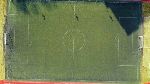 Flying up from a rural small stadium. Empty stadium camera moving up. Stock Footage 125877722