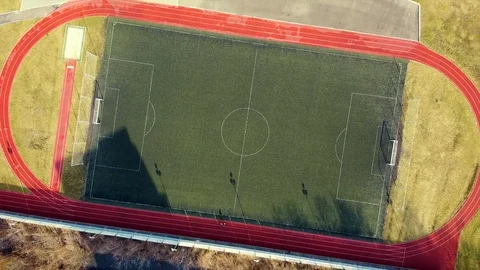 Flying up from a rural small stadium. Empty stadium camera moving up. Stock Footage 125878644