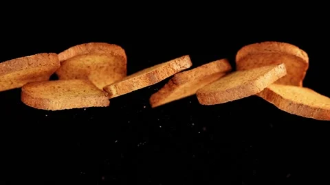 Flying rusk infron of black background Stock Footage 163202551