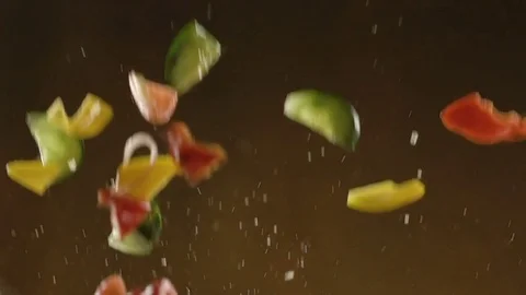 Flying Salad vegetables isolated on black background. Sliced floating. Slow Stock Footage 75059189