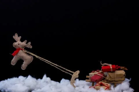 Flying Santa's reindeer drags a small sled full of Christmas gift Stock Photos