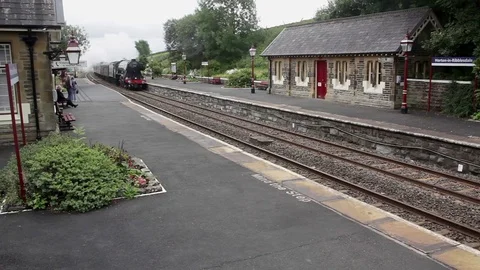 Flying Scotsman speeds through Horton in Ribblesdale station with steam train Stock Footage 80205877