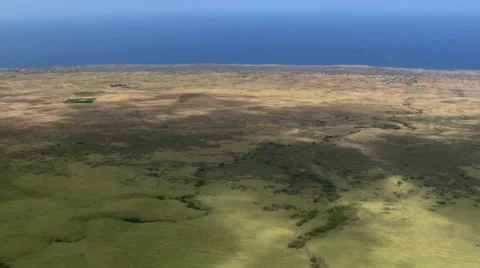 Flying seaward over rolling brown hills in Hawaii Stock Footage 59245718