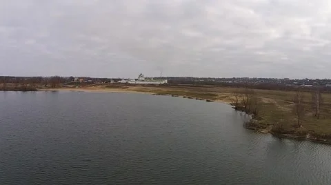 Flying on the shore of the lake with views of the monastery Stock Footage 45980260
