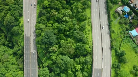 Flying shot over two parallel roads on the Pune Mumbai expressway around Stock Footage 139707563