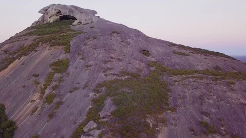 Flying up the side of a mountain with a cave at the top Stock Footage 105409044