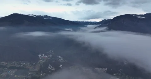 Flying on the side on top of the clouds. Beautiful mountain scenery in Europe Stock Footage 174418053