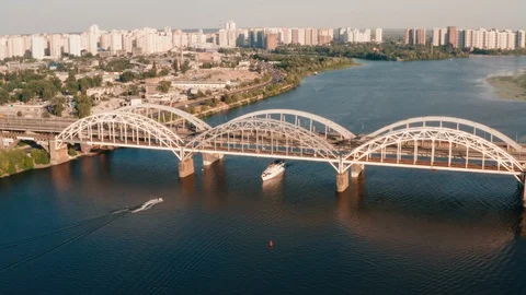 Flying sideways the camera looks directly at the bridge under which the ship Stock Footage 111877696