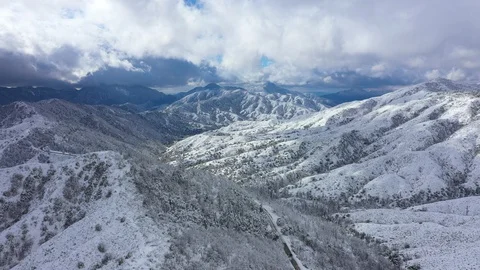 Flying sideways on top of snow covered mountain range Stock Footage 120635702
