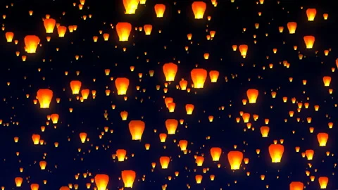 Flying sky lanterns in the night sky Stock Footage 107133739