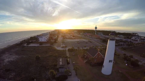 Flying slide right past a lighthouse with sunset in the distance. Stock-Footage 90642814