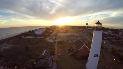 Flying slide in slow motion right past a lighthouse with sunset in the distance. Stock Footage 90561558