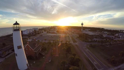 Flying sliding left past a lighthouse with sunset in the distance 2 Stock Footage 90561489