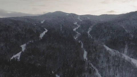 Flying up the slope of an abandoned ski mountain at sunset AERIAL 스톡 동영상 122690722