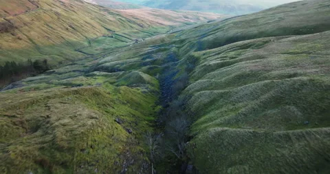 Flying on the slopes of a hill Stock Footage 307292540
