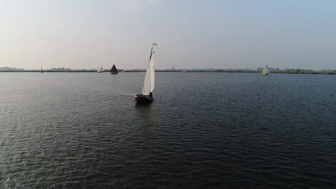 Flying slowly around old sailing ship on sunny day - Aerial Stock Footage 103353623