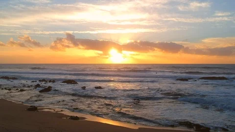 Flying slowly over beach at sunset to ocean in summer Stock Footage 95120157