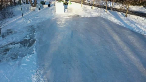 Flying slowly over a skating ring towards the ice slide which is being built Stock Footage 164250463