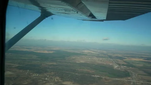 Flying in a small light plane. Aerial view from the window of a small aircraft Stock Footage 169857916