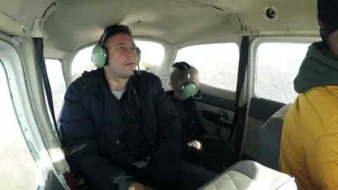 Flying in a small light plane. A man father with a boy child in the cabin  Stock Footage 169858144
