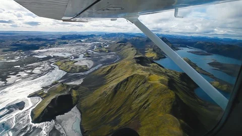 Flying on small plane above volcanic landscape in Iceland, view from the window Stock Footage 108993970