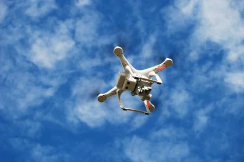 Flying Small Toy Drone on the Cloudy Sky. Stock Photos