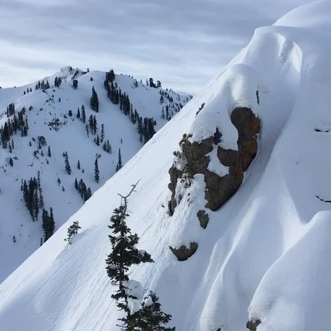 Flying by snow capped peaks at Squaw Valley  KT-22 in the back Stock Footage 98267384