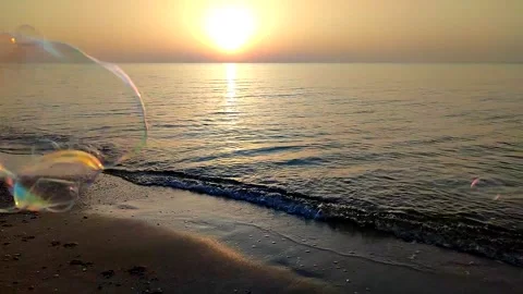 Flying soap bubbles on background of the sea during sunset. Lots of soap bubbles Stock Footage 250507276