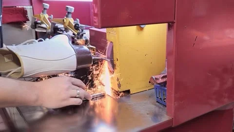 Flying sparks while sharpening an ice skate. Close-up of ice skate sharpened Stock Footage 252008238