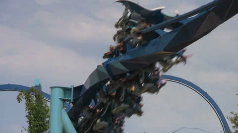 Flying Steel Roller Coaster Doing Corkscrew with Sreaming Passengers Video stock 23709956