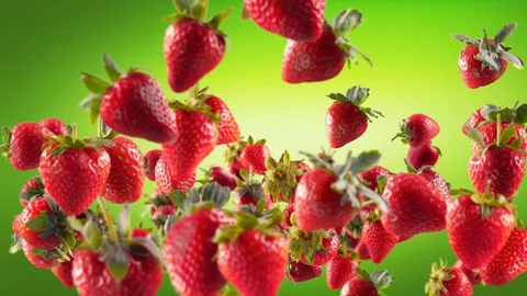 Flying of Strawberry in Green Background Stock Footage 129404723